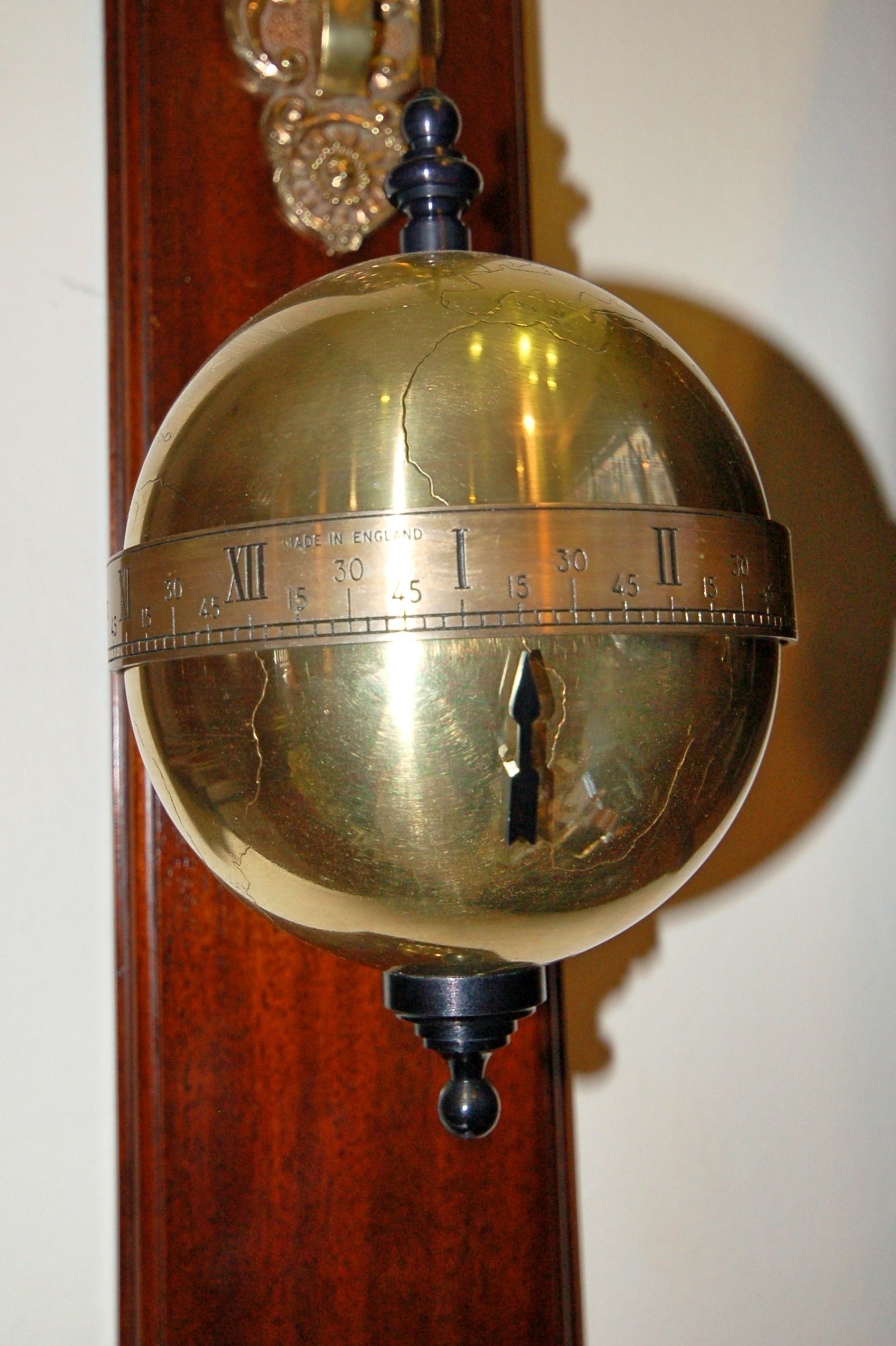 Globe time dial on this falling ball clock